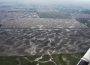 An aerial view of the ground, showing shimmering lines that tell us where the wetlands are.