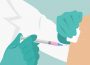 A graphic of someone receiving a needle in their upper arm. The person giving the injection is wearing blue gloves and a lab coat, and the liquid in the syringe is tinged pink.
