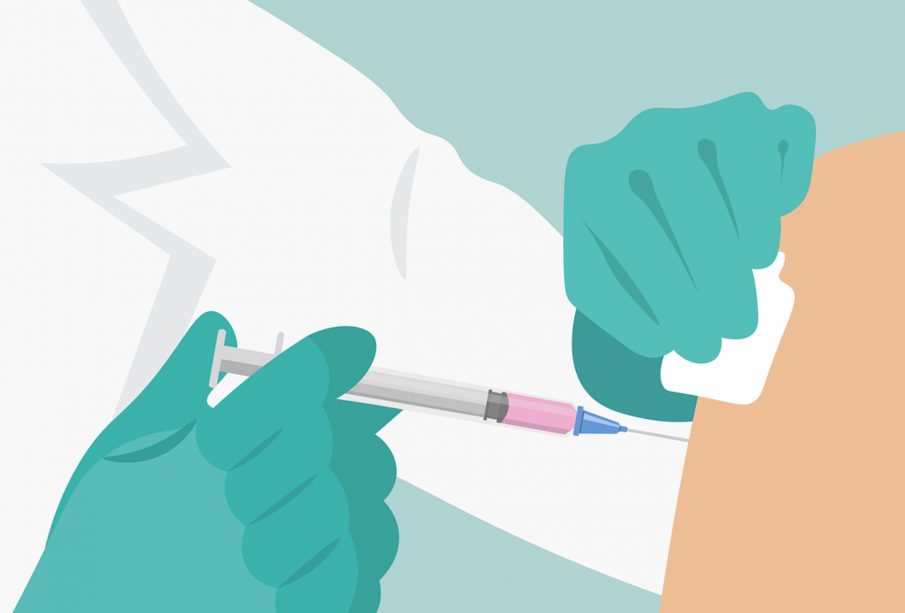A graphic of someone receiving a needle in their upper arm. The person giving the injection is wearing blue gloves and a lab coat, and the liquid in the syringe is tinged pink.