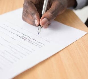 A photo of a sign indicating where to go vote through the words “Voting Place” and an arrow pointing to the left of the photo.
