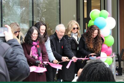 A group of people participate in the ribbon-cutting ceremony at the kikaskihtânaw Centre.