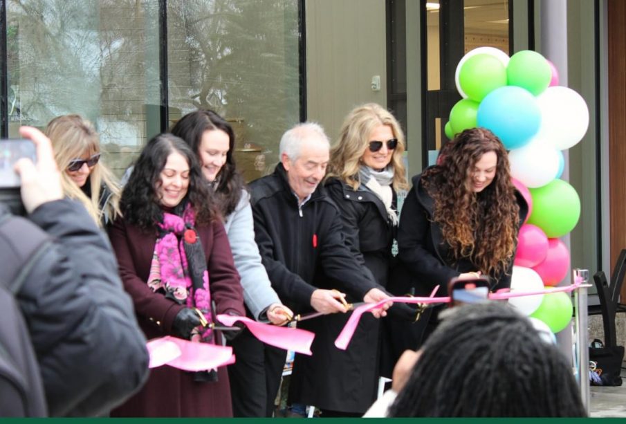 A group of people participate in the ribbon-cutting ceremony at the kikaskihtânaw Centre.