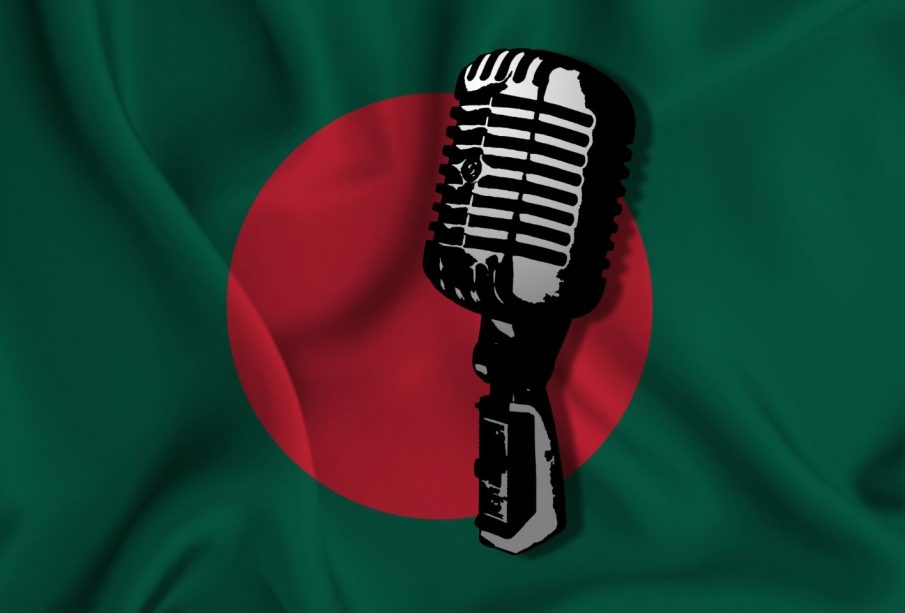 an illustration of a microphone is in front of the flag of Bangladesh. The microphone is in black and white, and the flag in red and green.