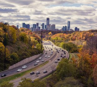 A photo of a winding road leading to the horizon.