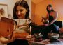 Allissa Hill, performing sound healing (right) and holding up a “Thai Massage” textbook (left).
