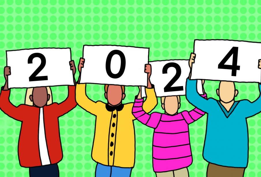 Four individuals in winter-type clothing hold up cards that form the number 2024.