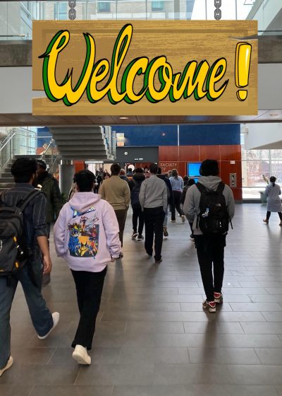 A group of students walk away from the viewer inside a large building