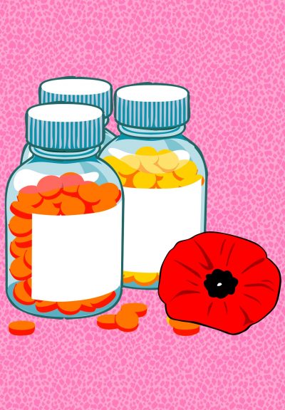 Three unlabelled, full pill bottles sitting beside a poppy flower.