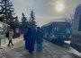 A photo of the Riddell Centre bus stop, with people lined up to board their buses