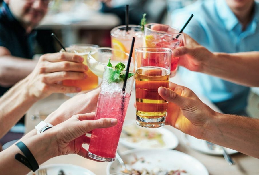 An image of people bringing their drinks together in the fashion of saying “Cheers!” during certain holiday dinners.