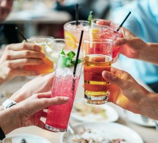 An image of people bringing their drinks together in the fashion of saying “Cheers!” during certain holiday dinners.