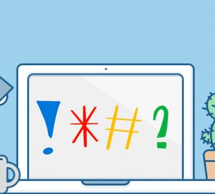 A laptop screen faces toward the viewer with an exclamation mark, asterisk, hashtag, and question mark on the screen. A task lamp, coffee mug, and cactus plant in a pot sit nearby on the desktop.