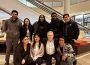 A group photo of several students with the Minister, everyone smiling.