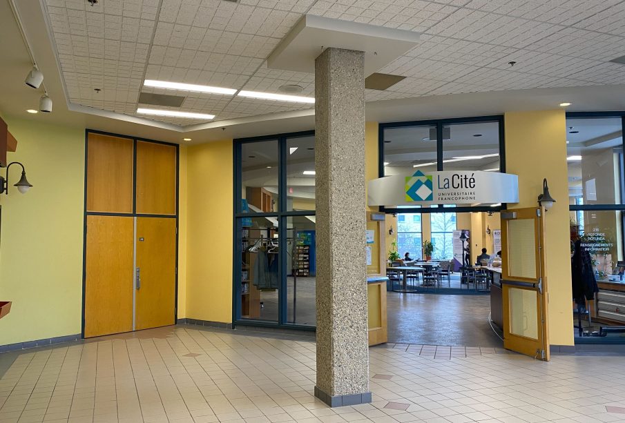 A photo of the outside of La Rotonde in La Cité. There are a few people inside it, but mostly it is empty.