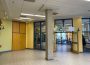 A photo of the outside of La Rotonde in La Cité. There are a few people inside it, but mostly it is empty.
