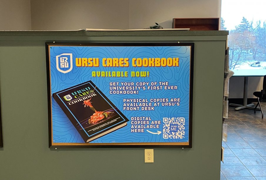  A photo of the URSU Cares Cookbook promotional poster found on the second floor of the Ridell Centre by the URSU front desk. There is a QR code on the bottom right of the poster that links to the online version of the cookbook.
