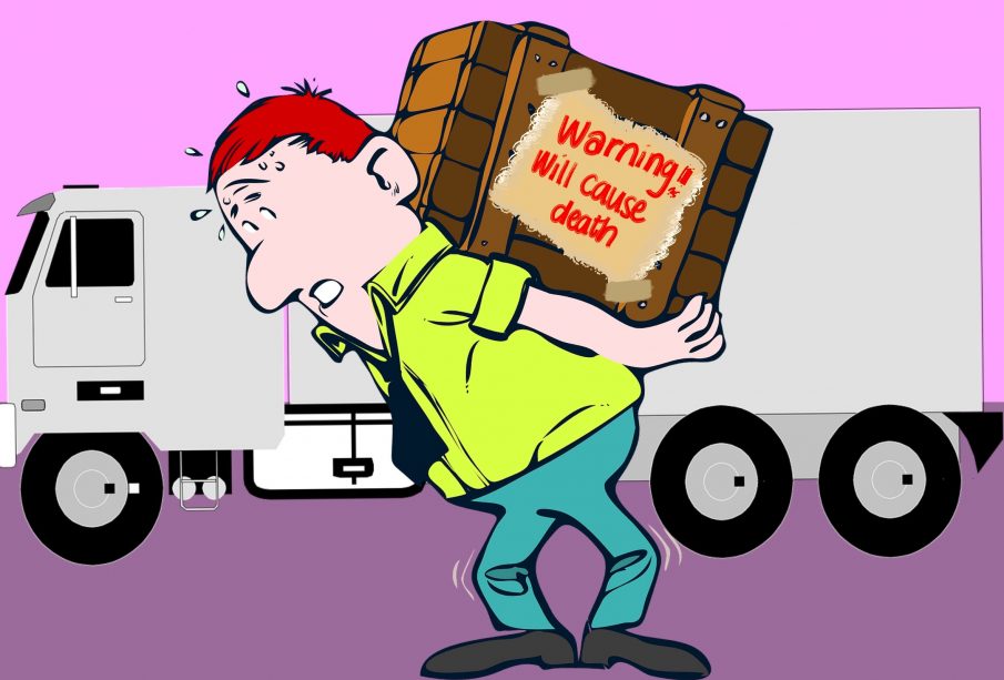 A person with short red hair and a bright green shirt carries a box on their back reading “Warning! will cause death”