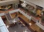 The Administration Humanities conversation pit is pictured from the fifth floor of the building. White snowflakes are drawn overtop the photo and are falling into the pit from the fifth floor.