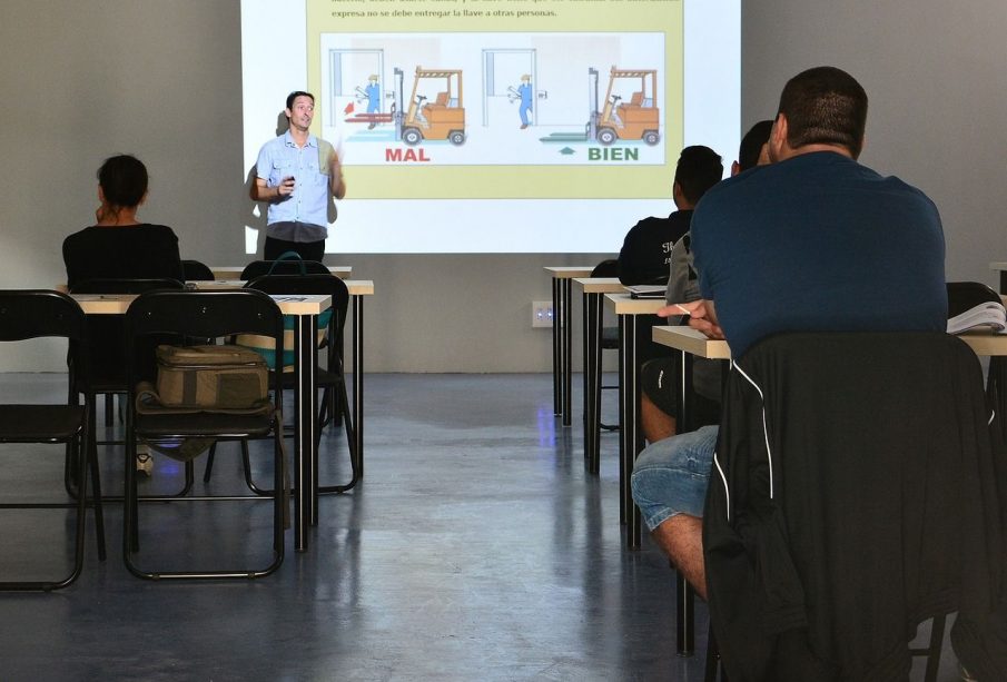A photo of a classroom with a number of empty chairs.