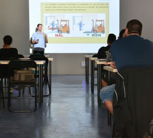 A photo of a classroom with a number of empty chairs.
