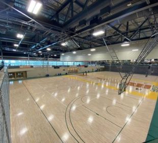 A photo of a University of Regina basketball gym from the second floor of the Centre for Kinesiology, Health, and Sport’s Fitness & Lifestyle Centre.