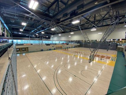 A photo of a University of Regina basketball gym from the second floor of the Centre for Kinesiology, Health, and Sport’s Fitness & Lifestyle Centre.