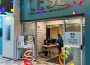 The CESL is pictured with its doors open, lights on, and people inside. Laid overtop the photo is multi-coloured confetti.