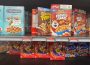 A photo of a cereal isle in a grocery store. In the photo are Kellog’s cereal brands, priced at “3 for $10.”