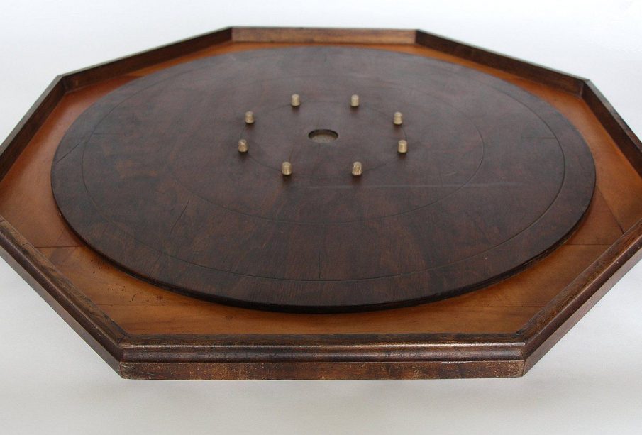 A photograph of a crokinole board on a white background.