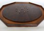 A photograph of a crokinole board on a white background.