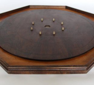 A photograph of a crokinole board on a white background.