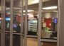 Cindy Gates is pictured preparing to open the Lab Café from behind its partially transparent storefront gates.