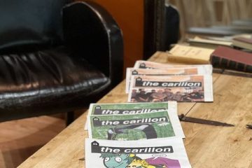 A photo of a table in a coffee shop, with some issues of the Carillon laid out.