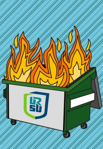 A green dumpster is on fire. URSU’s logo is on the front of it.