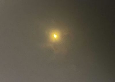 A photo of the April 8, 2024 solar eclipse taken through specialized eclipse-viewing glasses. The sun looks like a heart.