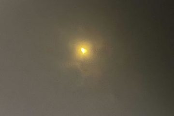 A photo of the April 8, 2024 solar eclipse taken through specialized eclipse-viewing glasses. The sun looks like a heart.