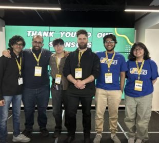 The UR Cybersecurity Club stands together, smiling at the camera.