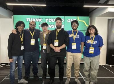 The UR Cybersecurity Club stands together, smiling at the camera.