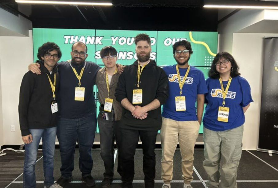 The UR Cybersecurity Club stands together, smiling at the camera.