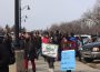 A crowd of teachers picket at the Saskatchewan legislature earlier this year. Two signs are visible, one reads, “SASK STUDENTS AND TEACHERS DESERVE BETTER!”
