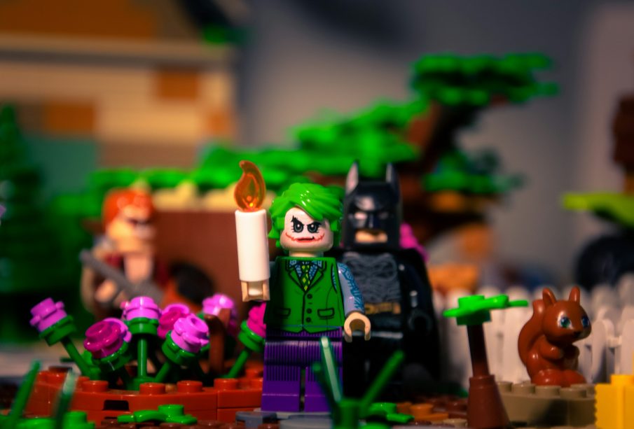 Lego action figures of Batman and The Joker, with several other figures in the background.