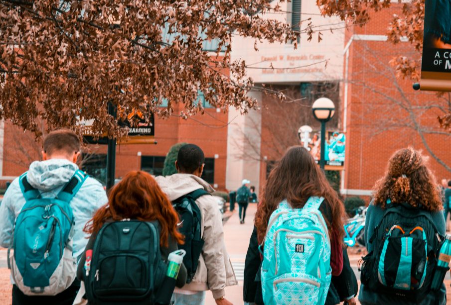 A photo from behind of a number of students walking in a group