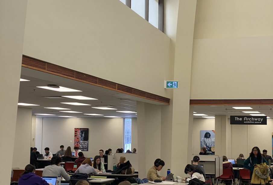 A photo of the Archer library main floor, with people studying at desks.