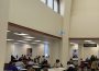 A photo of the Archer library main floor, with people studying at desks.