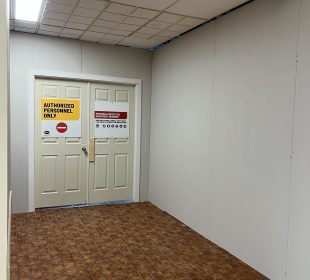 A sign is posted on a temporary door reading “authorized personnel only” walls are covering the space where the lab cafeteria is.