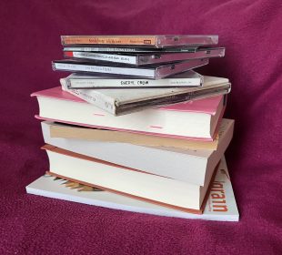 A photo of a stack of books and CDs