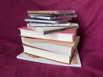 A photo of a stack of books and CDs