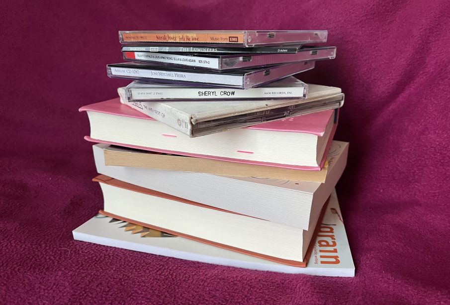 A photo of a stack of books and CDs
