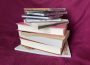 A photo of a stack of books and CDs