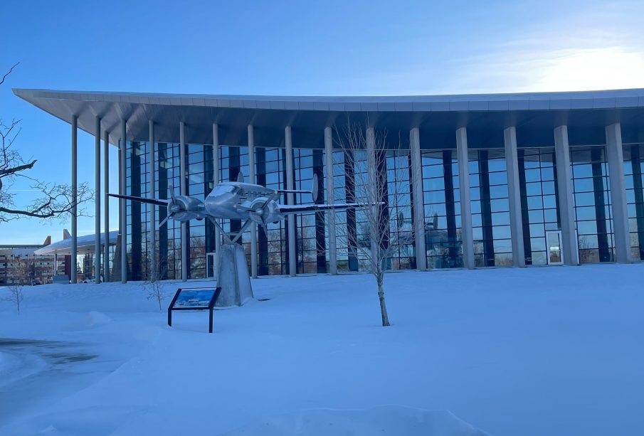 The RCMP Heritage Centre surrounded by snow and a low sun.